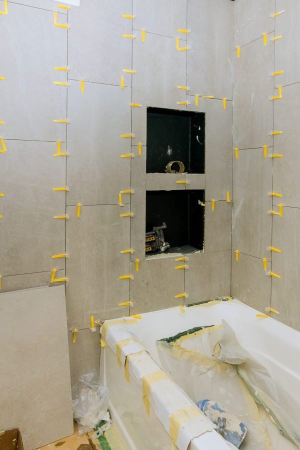 Construction work installing ceramic tile on reconstruction of bathroom during or renovation